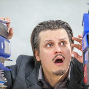 A young businessman working from his office - the concept of stress