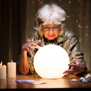 Photo of woman foretelling future from crystal ball